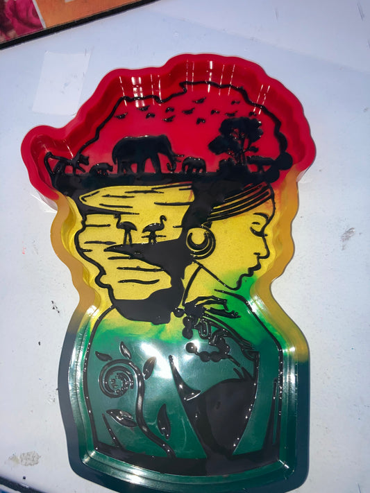 A colorful resin tray with a profile illustration of a woman on it, featuring red, yellow, and green hues.